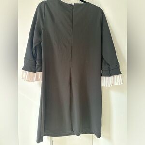 Neiman Marcus black dress with white ruffle and bow on sleeves